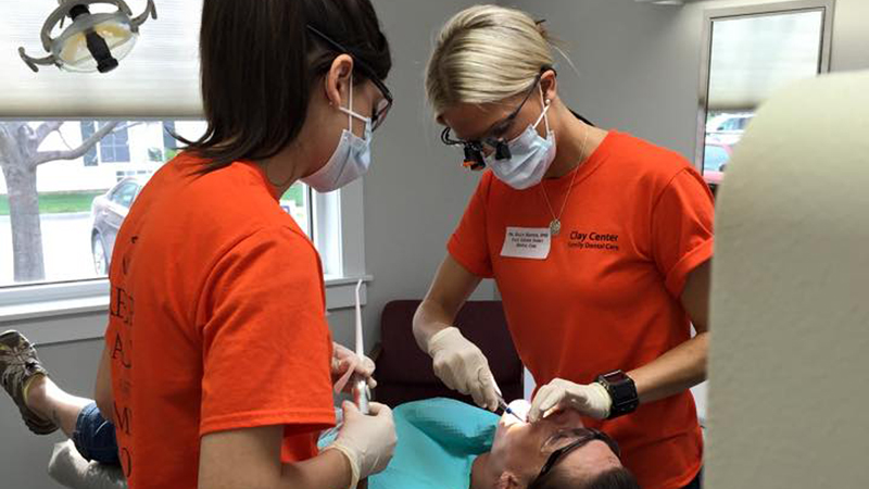 Dr. Harness and a team member working on a patient on Clay Center Family Dental Care Mission day