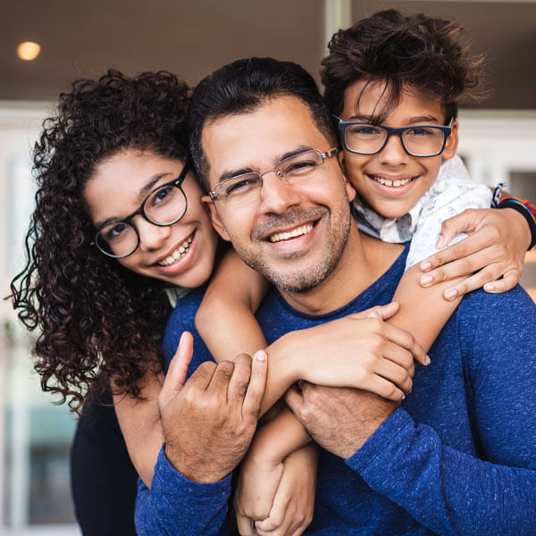 father smiling together with son and daughter