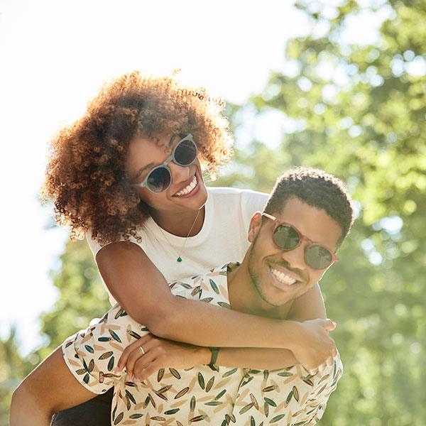 young man and woman smiling together outdoors