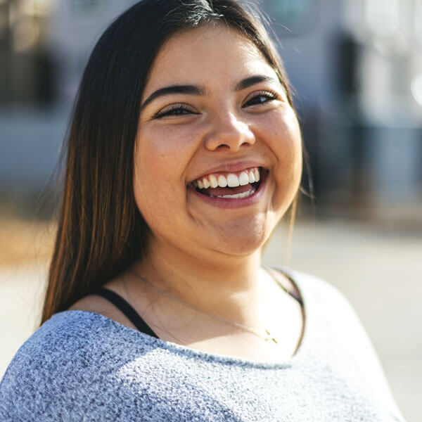 young woman smiling outdoors