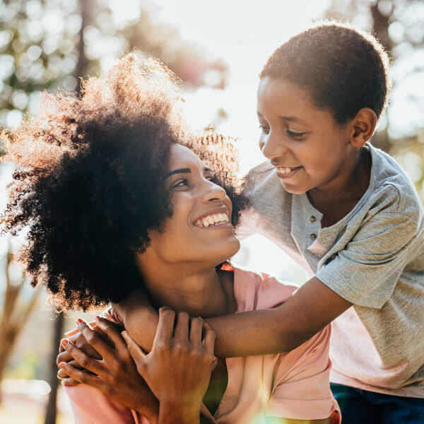 mother and son smiling together outdoors