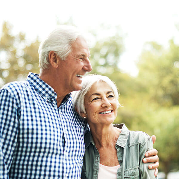 senior man and woman smiling together outdoors