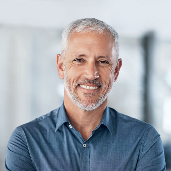 mature man smiling indoors